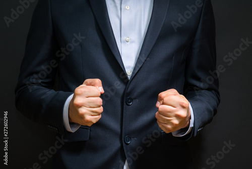 Photography Business man fists clenched in anger. Annoying emotions at work