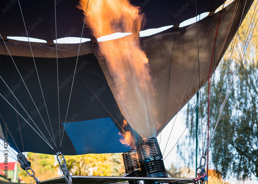 Obraz premium Hot air balloon. Aerostat with bright burning fire flame fueled