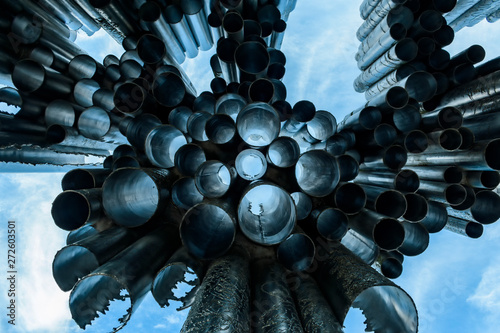 beautiful postcard monument with a bright blue sky on background. abstract silver tubes with reflections