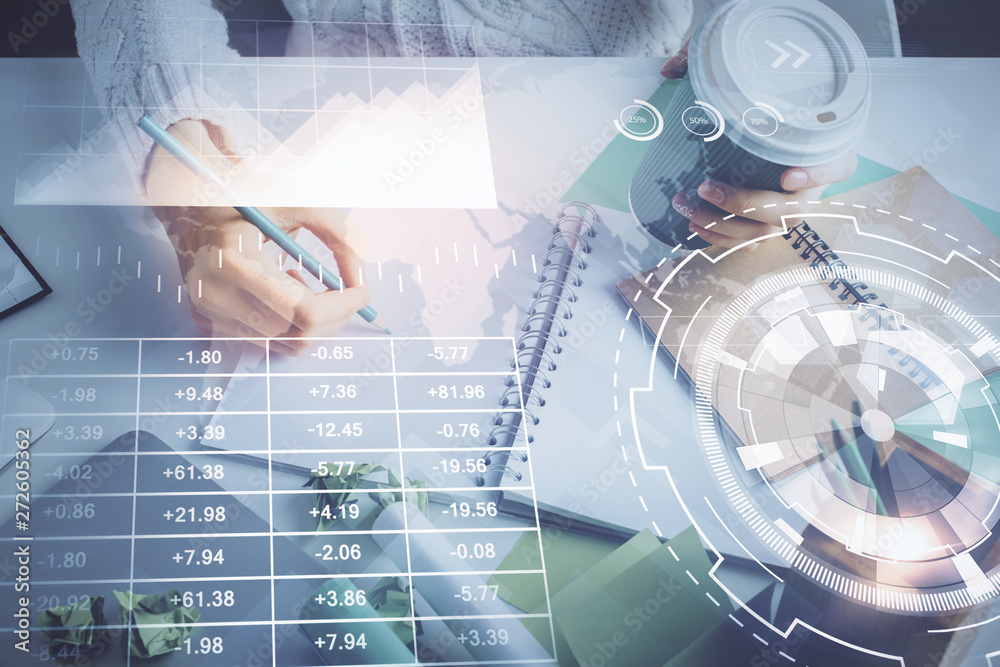 Financial forex graph displayed on hands taking notes background. Concept of research. Multi exposure Financial forex graph displayed on hands taking notes background. Concept of research. Multi exposure