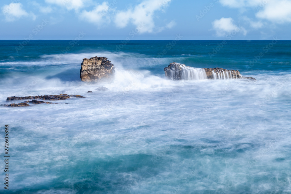 Long exposure of limestone stacks resembling a dog Long exposure of limestone stacks resembling a dog