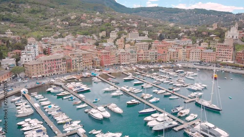 Aerial shot. Santa Margherita Ligure is a beautiful resort town on the Ligurian coast in Italy. View from the bay, in the frame of the yacht and the city pier, with beautiful houses. photo