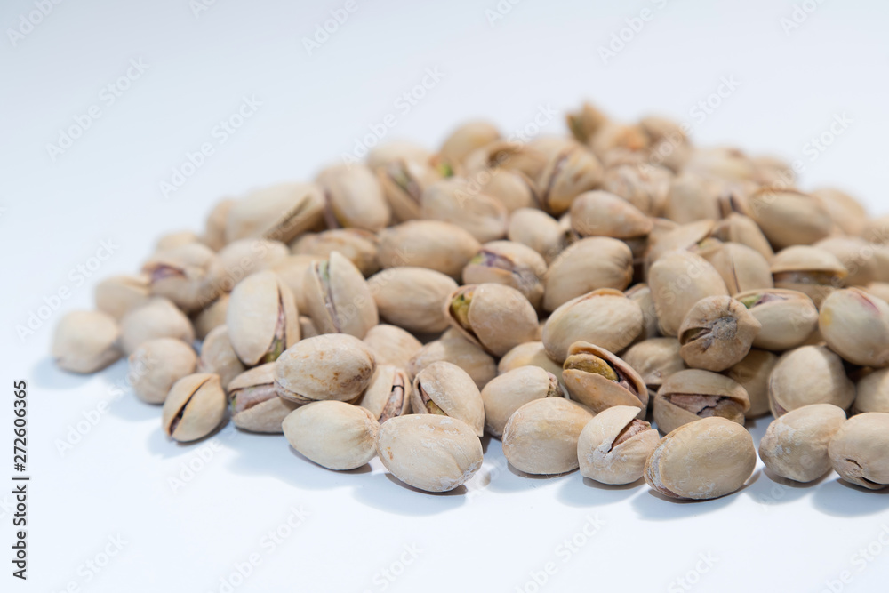 Pistachios nuts on white background with space for type. Food mi