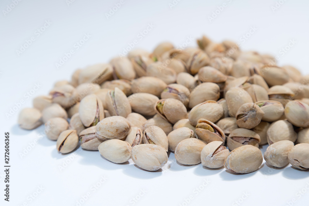 Pistachios nuts on white background with space for type. Food mi Pistachios nuts on white background with space for type. Food mi