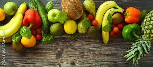 Fruti and vegetables background. Different fruits and vegetables over wooden background. Banner. Copy space. photo