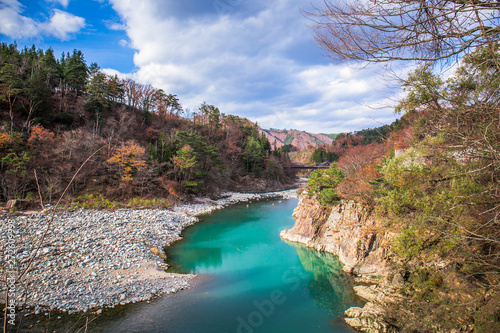 The Shogawa river is beautiful and the water is in emerald color and It runs through the village of Shirakawa-go, Japan.