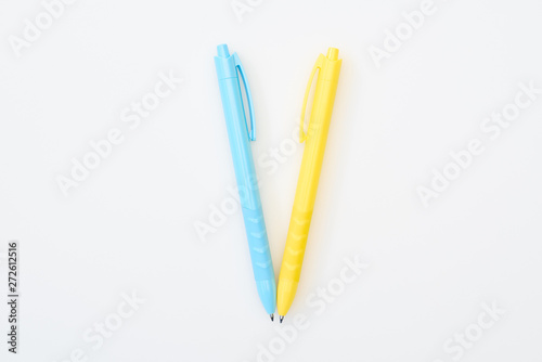 top view of yellow and blue crossed pencils isolated on white © LIGHTFIELD STUDIOS