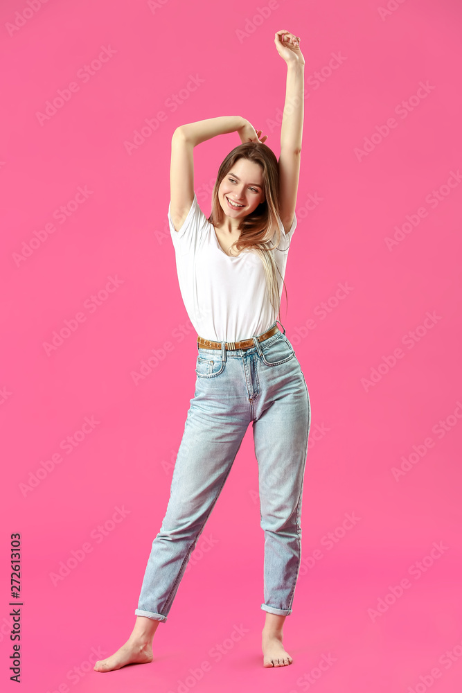 Stylish young woman in jeans on color background Stylish young woman in jeans on color background