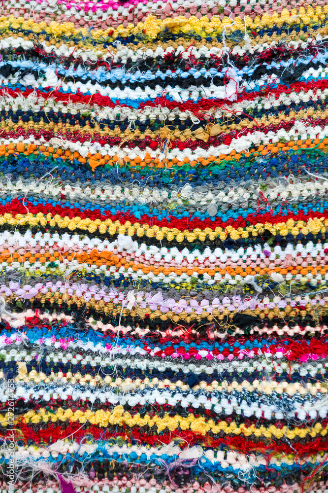 Colorful textile abstract background in a full frame close-up of imperfect woven layers Colorful textile abstract background in a full frame close-up of imperfect woven layers