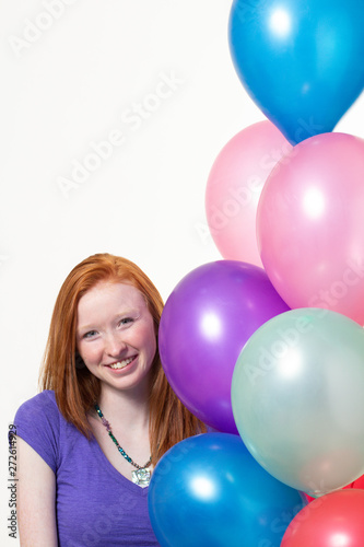 happy birthday girl with red hair and colorful balloons