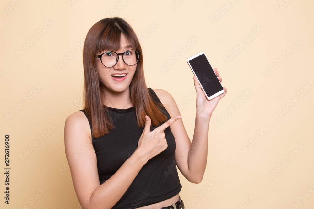 Excited Young Asian woman point to mobile phone. Excited Young Asian woman point to mobile phone.