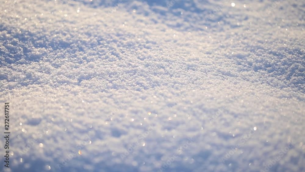 Sunny macro texture of fresh snow on winter sunset time. Beautiful sparkling nature background.