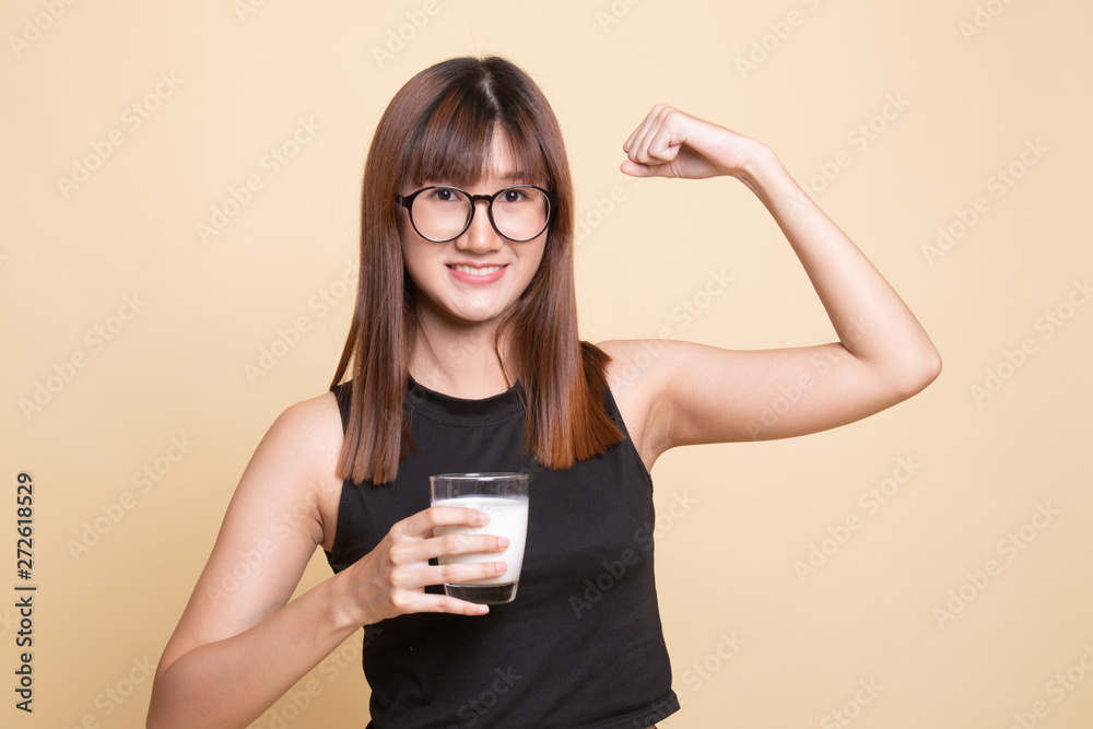 Healthy Asian woman drinking a glass of milk.