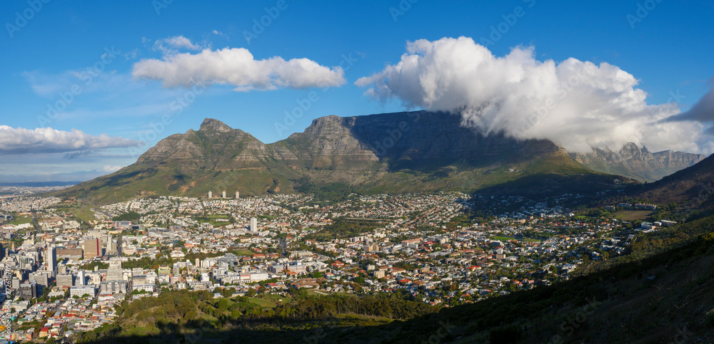 Dramatic views of Cape Town City Bowl, Devil's Peak and a cloud covered Table Mountain from Lion's Head. Western Cape. South Africa