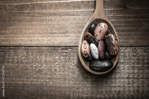 Colorful Beans and Wooden Spoon on Rustic Dark Background
