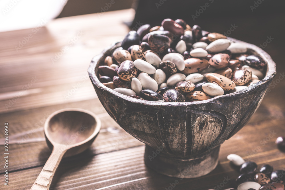 Fototapeta premium Colorful Beans and Wooden Spoon on Rustic Dark Background