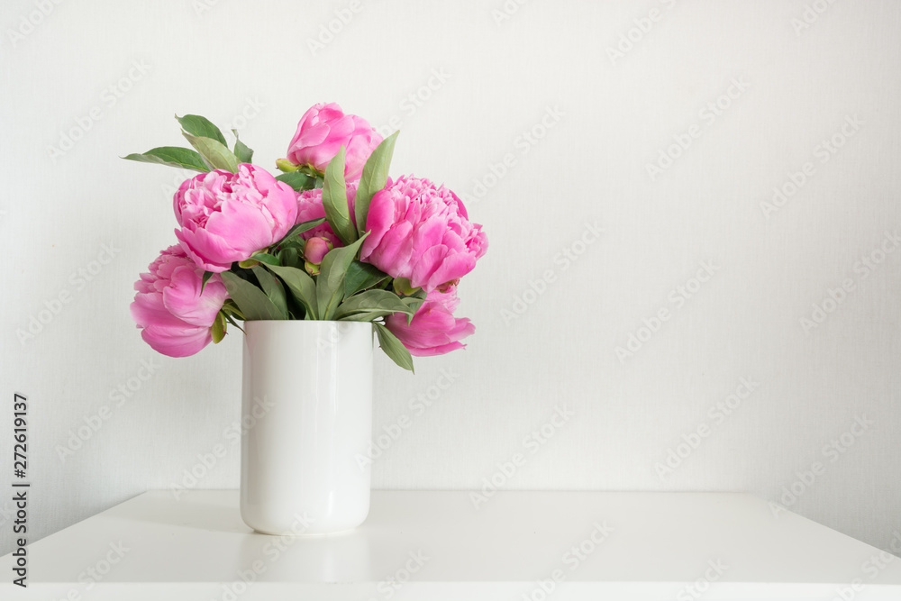 Pink peony in vase on white. Copy space for text. Mothers day.