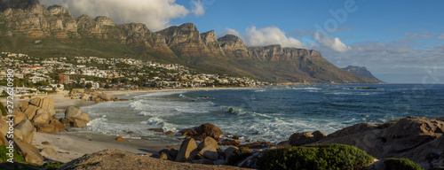 Beautiful coastal view of Camps Bay coastline and 12 Apostles with Atlantic Ocean waves breaking onto rocks and beach. Cape Town. Western Cape. South Africa.