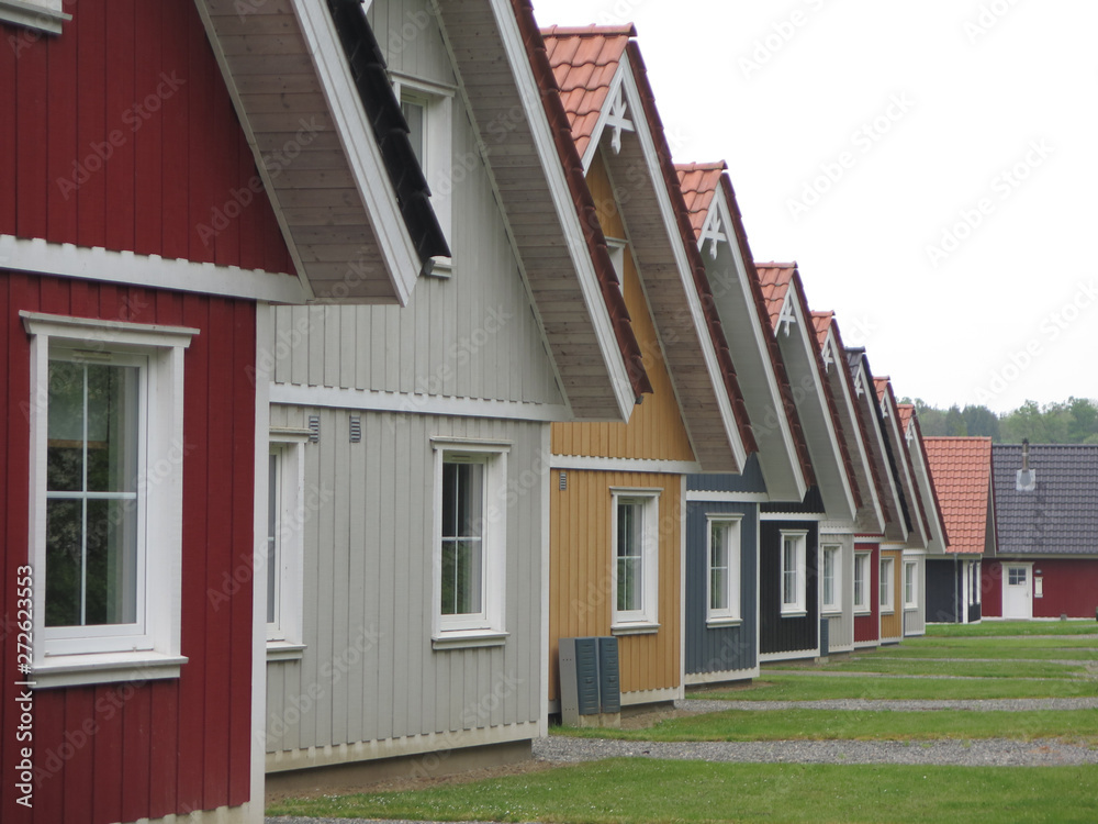 Perspective view of identical wooden holiday homes Perspective view of identical wooden holiday homes