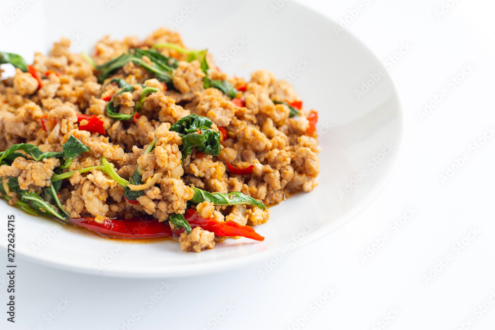 Stir-fried hot and spicy pork with basil on white. Stir-fried hot and spicy pork with basil on white.