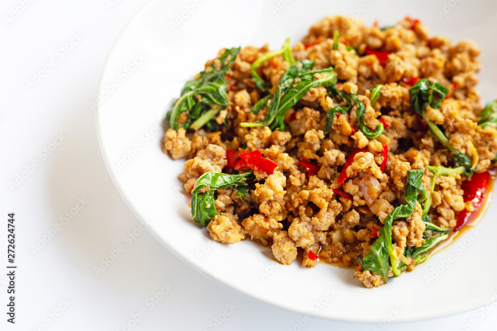 Stir-fried hot and spicy pork with basil on white. Stir-fried hot and spicy pork with basil on white.