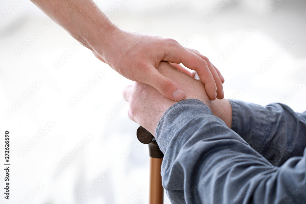 Caregiver with senior man in nursing home, closeup