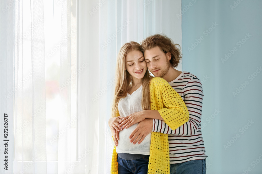 Happy young pregnant couple at home Happy young pregnant couple at home