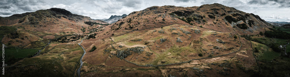 Aerial over the lake district with mountains and hills and dramatic sky, England panoramic