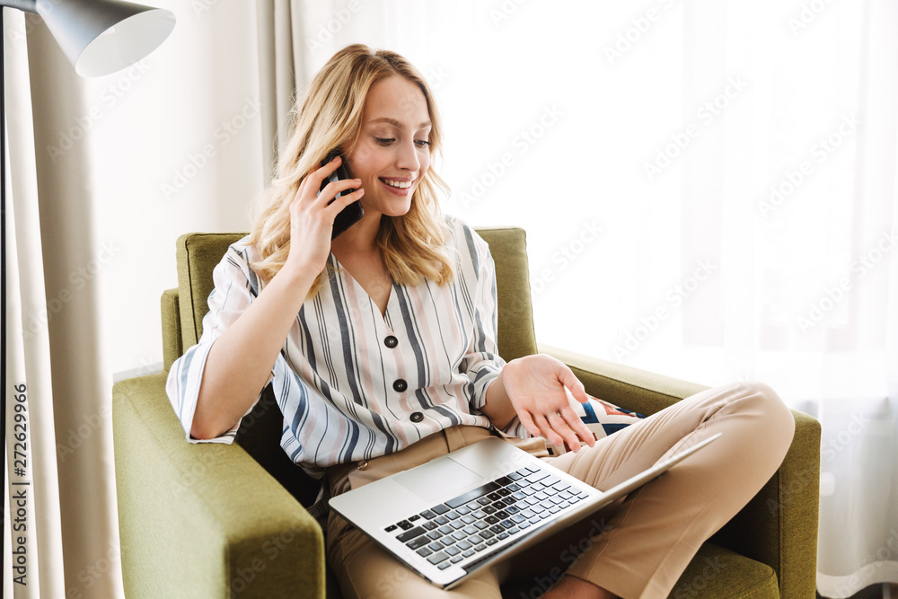 Beautiful young blonde woman sitting in armchair Beautiful young blonde woman sitting in armchair