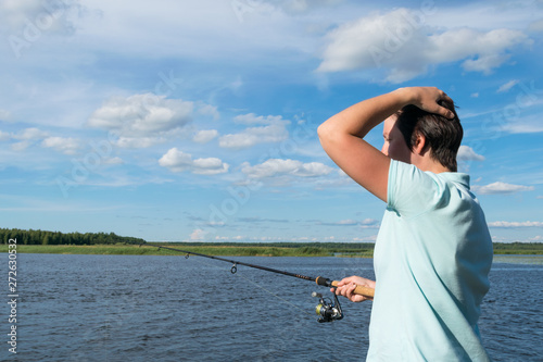Wallpaper Mural girl thinking how to catch a fish on a spinning in good weather on the river Torontodigital.ca