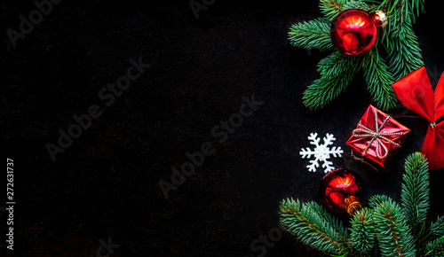 Christmas decoration on dark black background. Flat lay. Christmas wallpaper with copy space