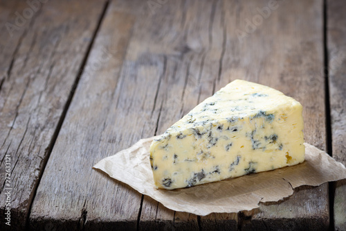 Blue cheese on wooden rustic table.