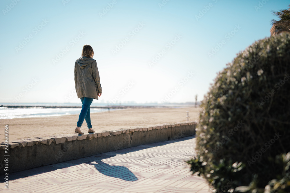 Waling woman on the beach Valencia Spain