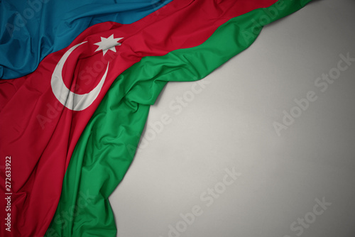 waving national flag of azerbaijan on a gray background.