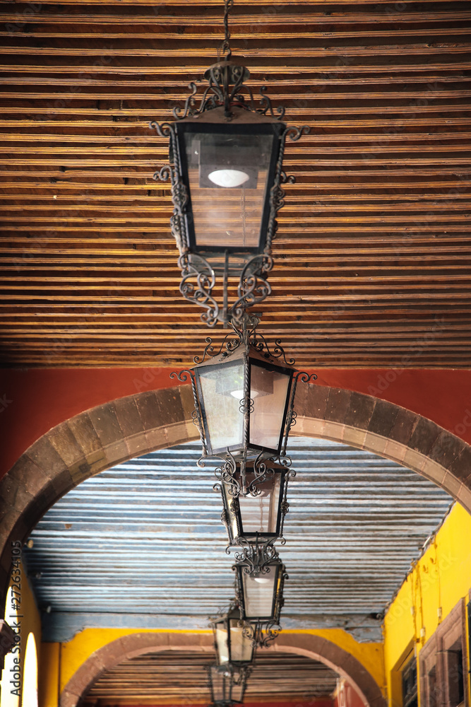 A colorful ceiling with oldschool laterns in San Miguel de Allende in Mexico