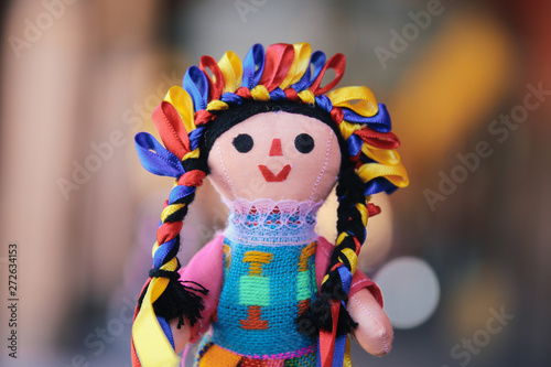 A hand-made mexican colorful doll with bokeh background