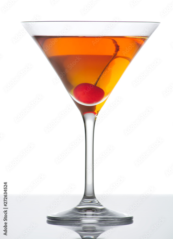 Manhattan drink with red cherry on white