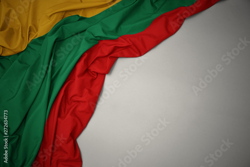 waving national flag of lithuania on a gray background.