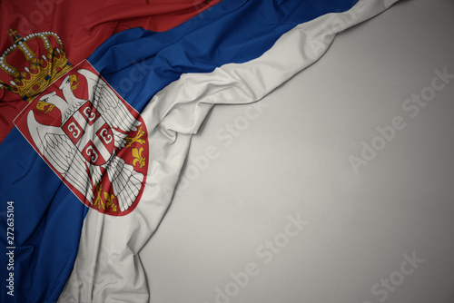 waving national flag of serbia on a gray background. photo