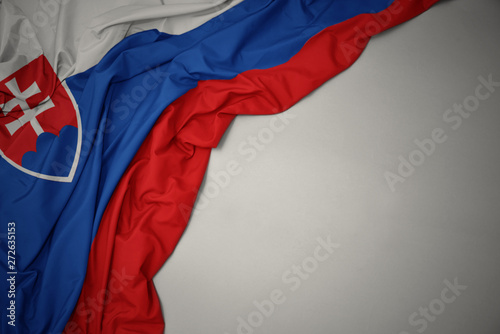 waving national flag of slovakia on a gray background. photo