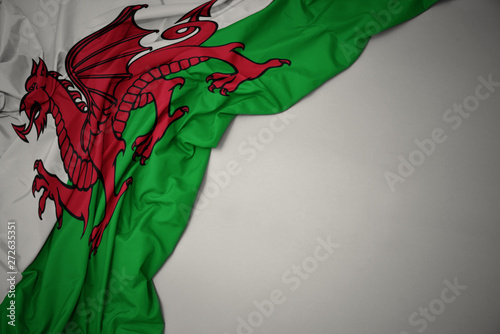 waving national flag of wales on a gray background.