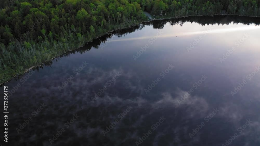 Looking down at the patterns of mist on a calm pond at sunrise AERIAL TOPDOWN Looking down at the patterns of mist on a calm pond at sunrise AERIAL TOPDOWN