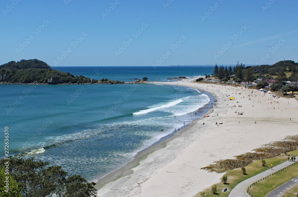 View of Tauranga from Mount Maunganui in New Zealand. The surf rolls on to the perfect sandy beach