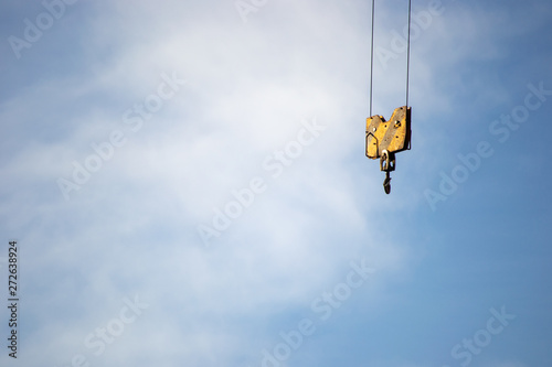 Part of a crane over a blue sky