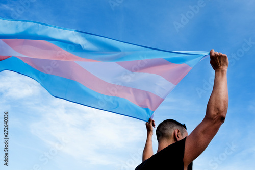 young person with a transgender pride flag photo