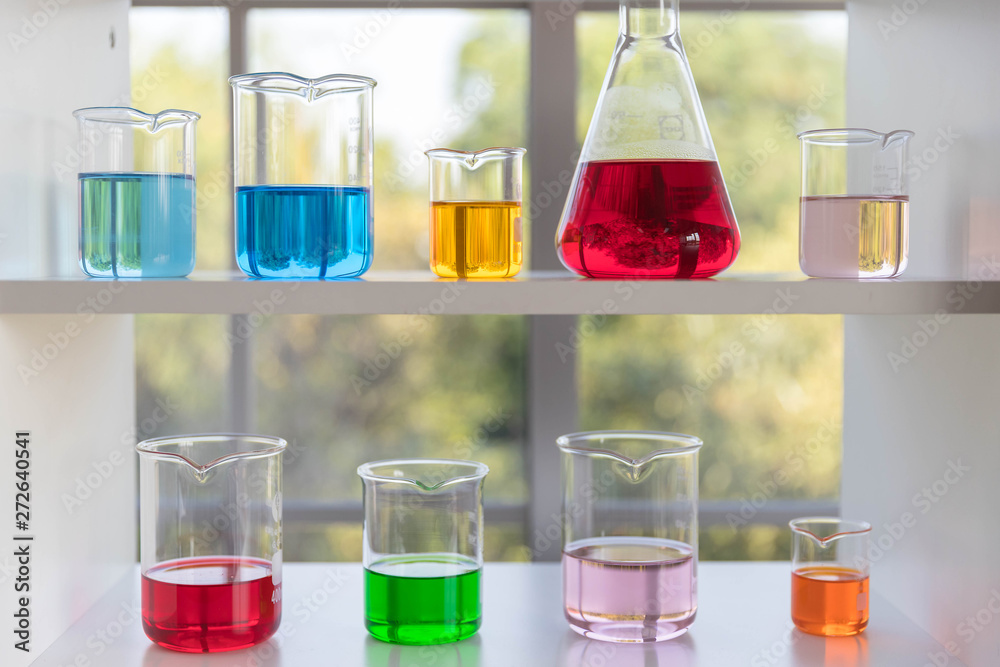 The different size of laboratory glassware on the white shelf. The different size of laboratory glassware on the white shelf.