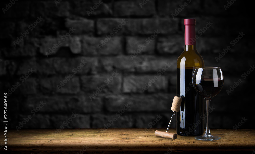 Red wine glasses and bottle on stone background. Top view with copy space