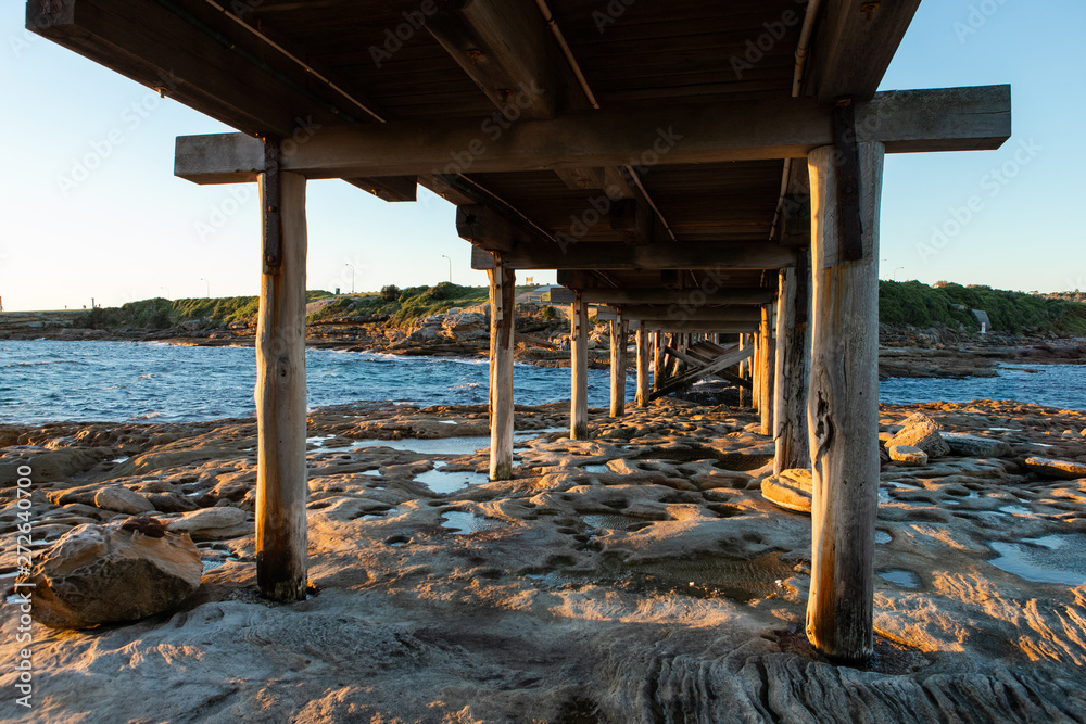 Fototapeta premium View under wooden bridge at the beach.