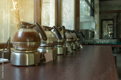 Hot Coffee brake pitcher set for service,many pitcher of hot coffee espresso on the table and light background photo