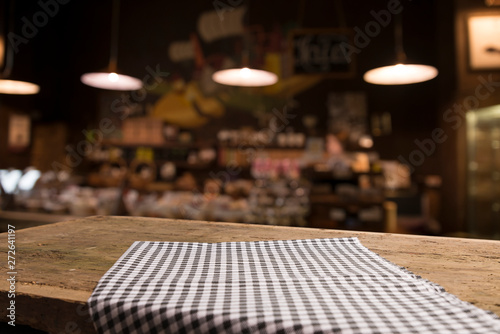 Table background with napkin and blurred bar background space